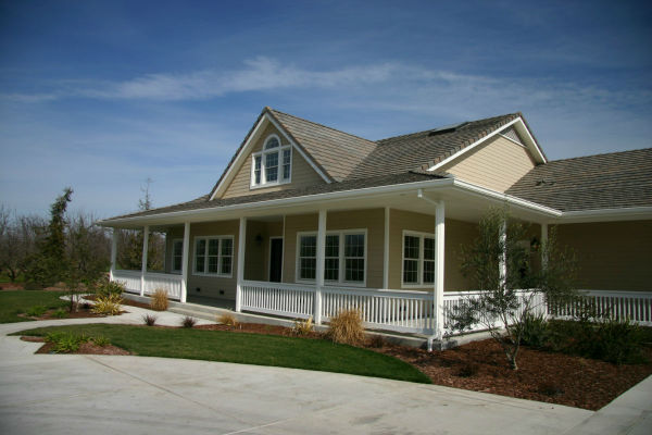 This ranch style custom home includes a large covered porch and patio to interact with the surrounding landscape.  This three bedroom, three bath house was designed with the Great Room concept and also includes a three car garage.